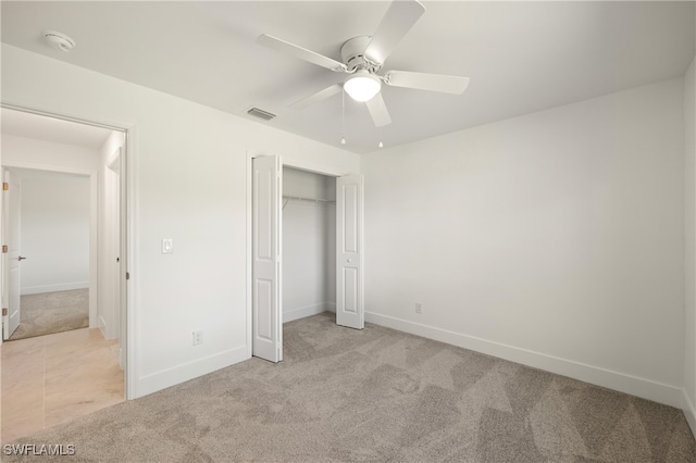 unfurnished bedroom featuring a closet, ceiling fan, and light carpet