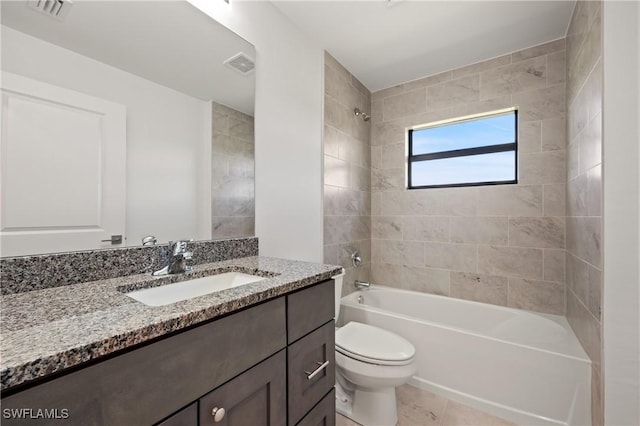 2611 NE 22nd Ave, Cape Coral, FL 33909 - bathroom with vanity, tub / shower combination, toilet, and tile patterned floors