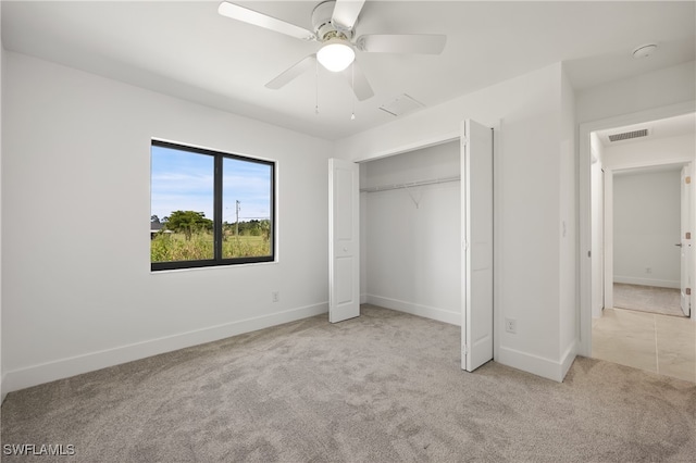 unfurnished bedroom with a closet, ceiling fan, and light carpet