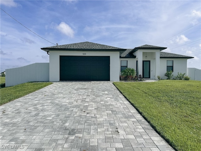 view of front of house featuring a front lawn and a garage