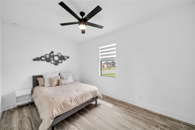 bedroom with wood-type flooring and ceiling fan