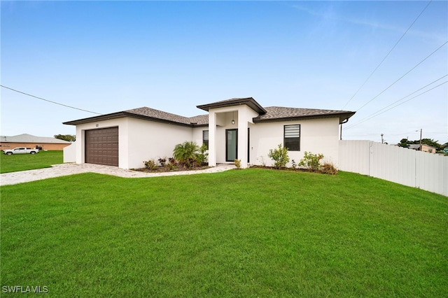 view of front of house featuring a front yard and a garage