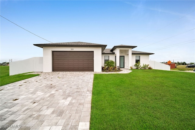 view of front of property with a front yard and a garage