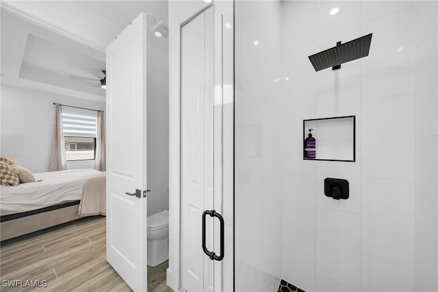 bathroom featuring hardwood / wood-style floors, toilet, and walk in shower