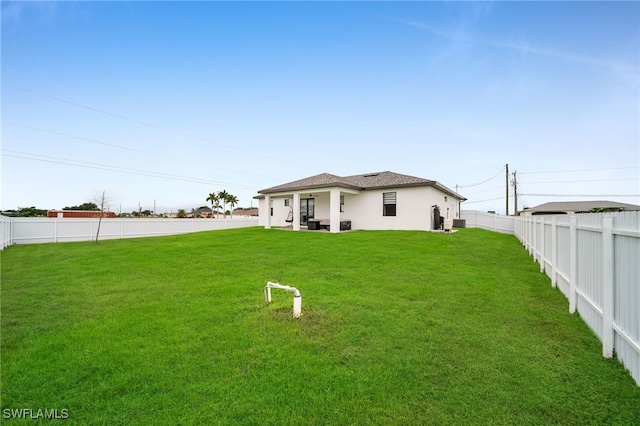 back of property featuring a yard