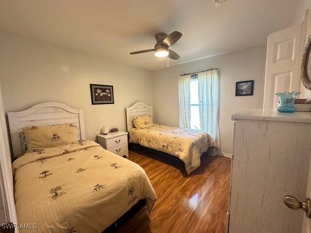 bedroom featuring ceiling fan and dark hardwood / wood-style flooring