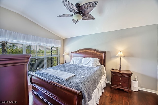 bedroom with dark hardwood / wood-style flooring, vaulted ceiling, and ceiling fan