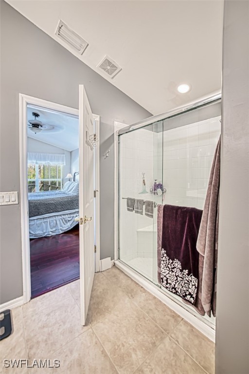 bathroom with lofted ceiling, hardwood / wood-style flooring, and an enclosed shower