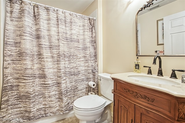 bathroom featuring toilet, vanity, and a shower with shower curtain