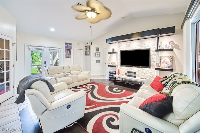 living room with french doors, lofted ceiling, ceiling fan, and hardwood / wood-style floors