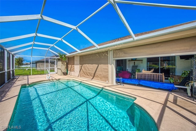 view of swimming pool with a lanai, a patio, and ceiling fan