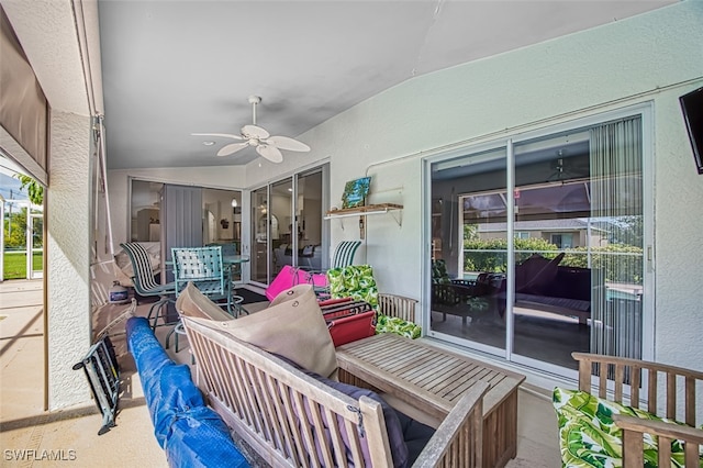 sunroom with ceiling fan and vaulted ceiling