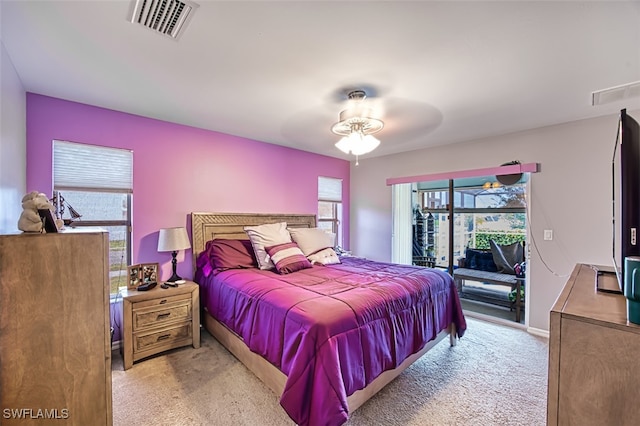 bedroom featuring light carpet, multiple windows, access to exterior, and ceiling fan