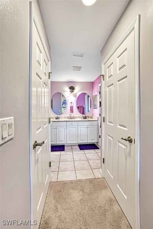 bathroom with tile patterned floors and vanity