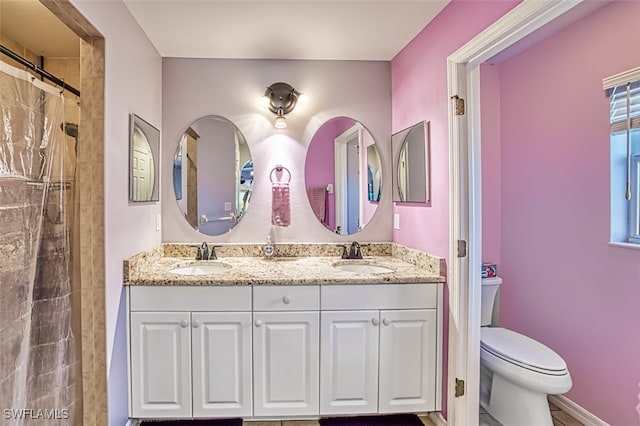 bathroom featuring walk in shower, vanity, and toilet