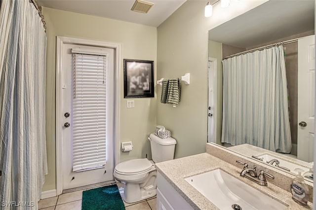 bathroom with walk in shower, vanity, toilet, and tile patterned floors