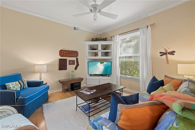 living room with ornamental molding, ceiling fan, and light hardwood / wood-style flooring