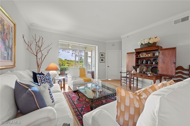 living room featuring crown molding, hardwood / wood-style floors, and ceiling fan