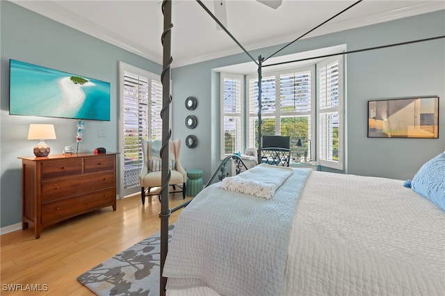 bedroom featuring ornamental molding and light hardwood / wood-style floors