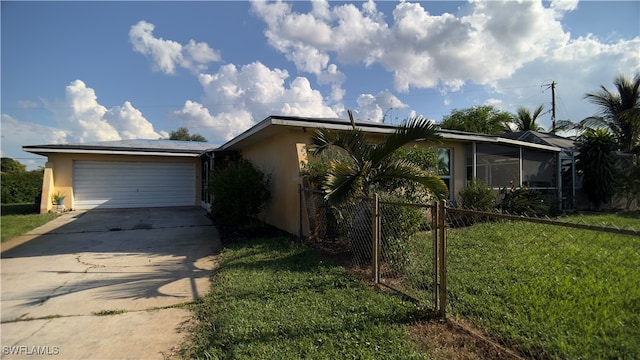 view of front of property with a garage and a front lawn