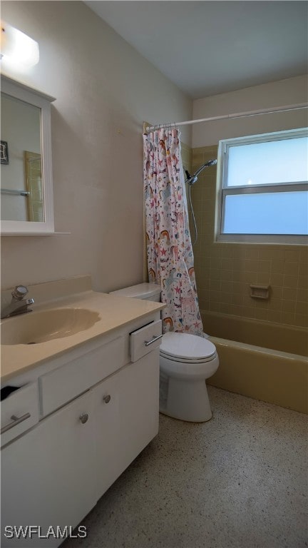 full bathroom featuring vanity, shower / tub combo, and toilet