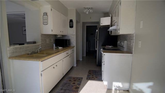 kitchen featuring white cabinetry, tasteful backsplash, and sink