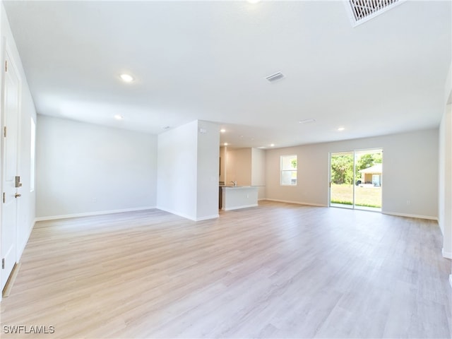 unfurnished living room with light wood-type flooring