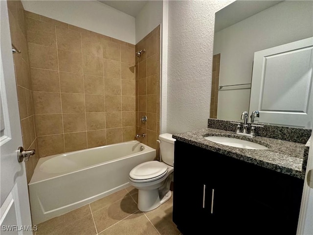 full bathroom featuring tiled shower / bath combo, vanity, tile patterned flooring, and toilet