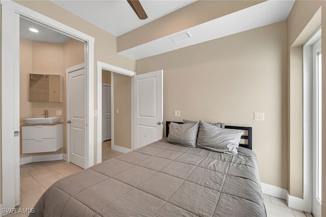 tiled bedroom featuring a closet, ceiling fan, and sink