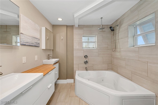 bathroom with vanity and shower with separate bathtub