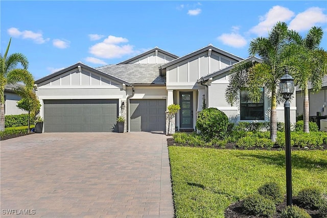 view of front of house with a front yard and a garage