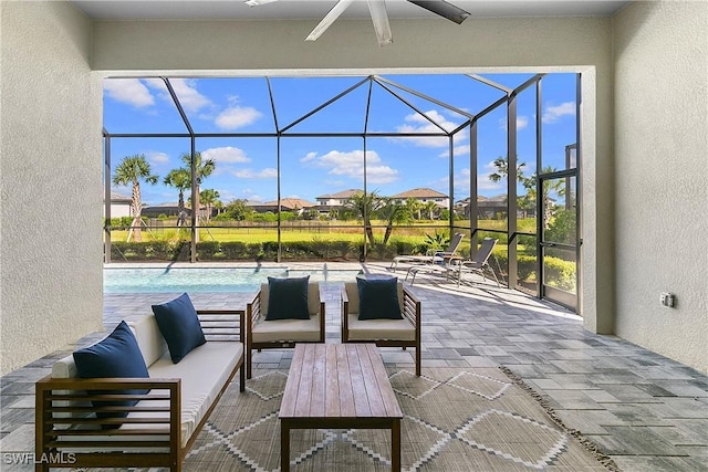 view of patio with outdoor lounge area, ceiling fan, and glass enclosure