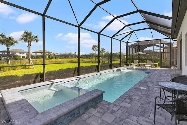 view of swimming pool with glass enclosure, an in ground hot tub, and a patio