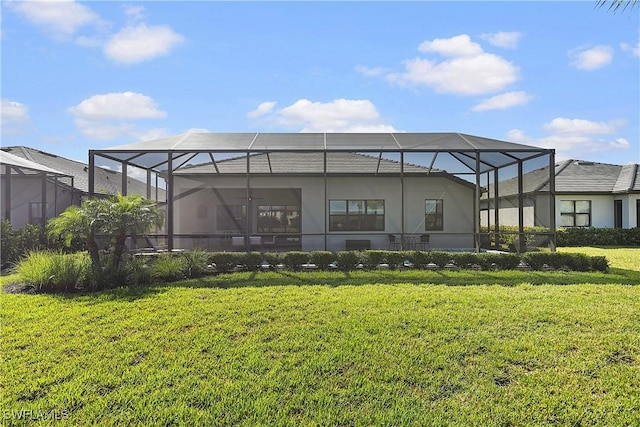 back of house featuring a yard and a lanai