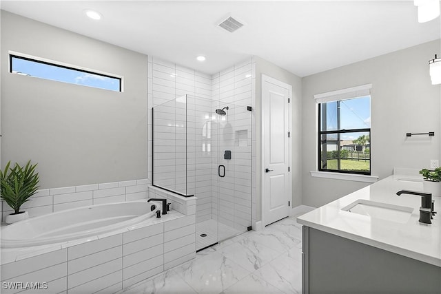 bathroom featuring vanity, a healthy amount of sunlight, and shower with separate bathtub