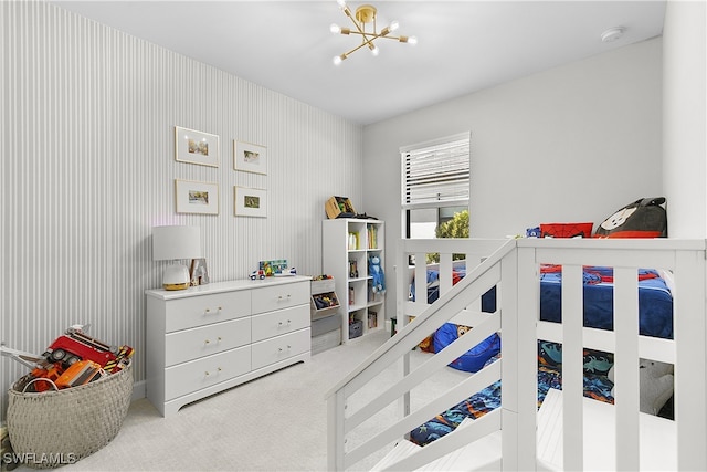 carpeted bedroom with a notable chandelier