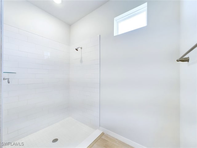 2138 Blaser St, Port Charlotte, FL 33980 - bathroom with baseboards, a tile shower, and wood finished floors