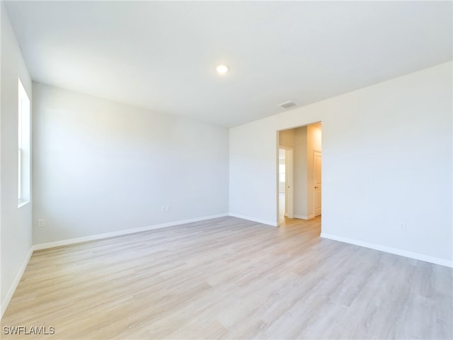 spare room with light hardwood / wood-style floors