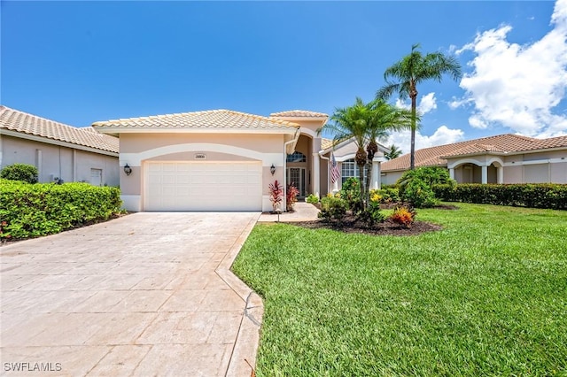 mediterranean / spanish-style house featuring a front yard and a garage