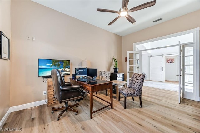 office with french doors, light hardwood / wood-style floors, and ceiling fan