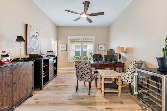 home office featuring light wood-type flooring, beverage cooler, and ceiling fan