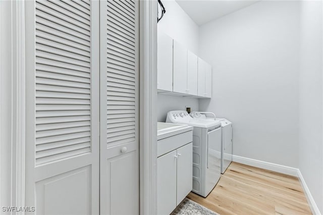 24800 Hollybrier Ln, Bonita Springs, FL 34134 - laundry room featuring cabinet space, washer and dryer, and light wood finished floors