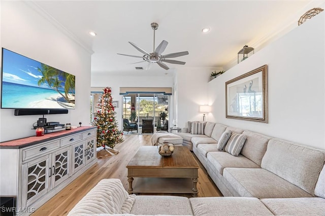 living room with ceiling fan, light hardwood / wood-style floors, and ornamental molding