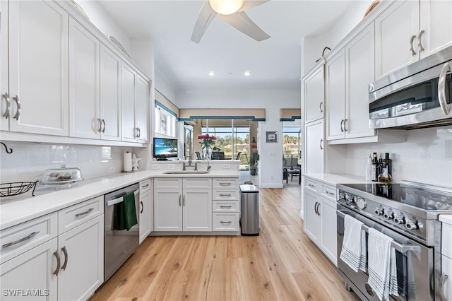24800 Hollybrier Ln, Bonita Springs, FL 34134 - kitchen featuring appliances with stainless steel finishes, ceiling fan, light wood-style floors, recessed lighting, and white cabinetry