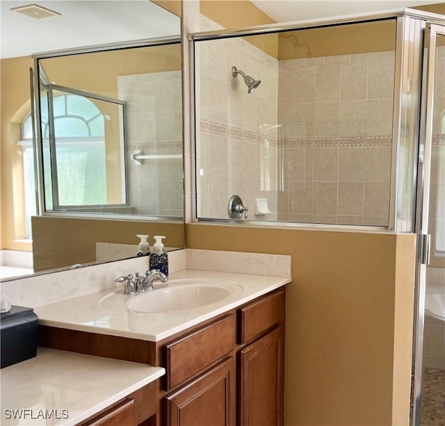 bathroom with vanity and an enclosed shower