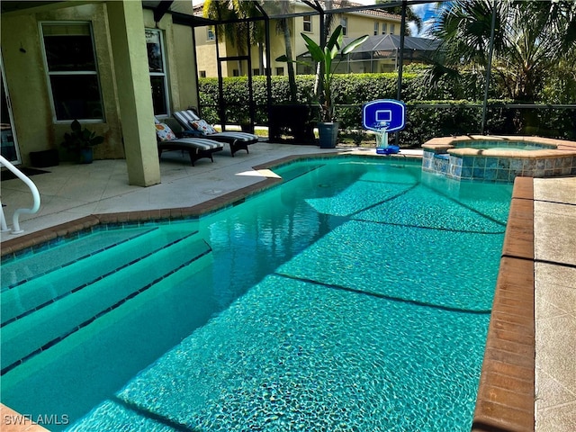 view of swimming pool featuring a patio, an in ground hot tub, and glass enclosure