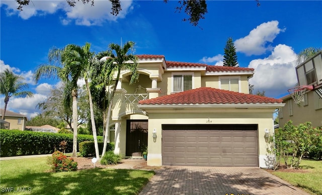 mediterranean / spanish-style home featuring a front yard and a garage