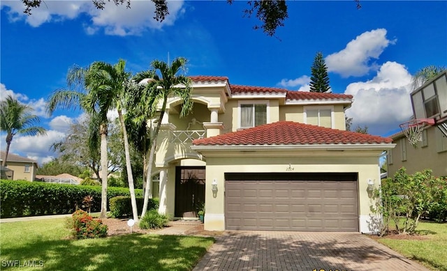 2004 Par Dr, Naples, FL 34120 - mediterranean / spanish home with a tiled roof, decorative driveway, an attached garage, and stucco siding