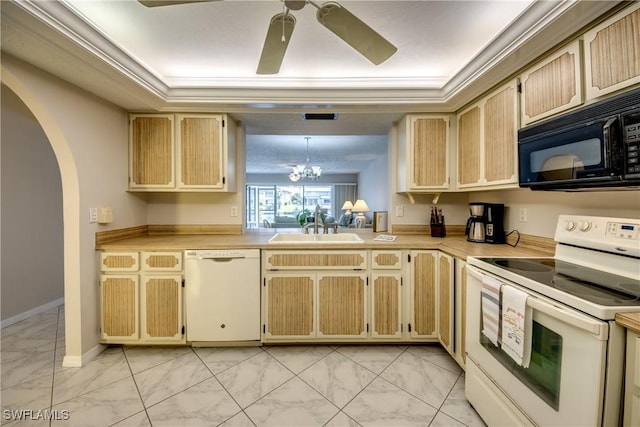 kitchen with white appliances, light brown cabinetry, a tray ceiling, and sink