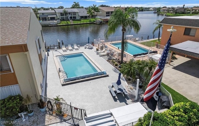 view of pool with a patio and a water view